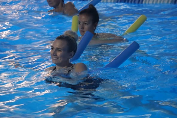 AquaSpin Transition & Rehab session showing participants enjoying water-based fitness